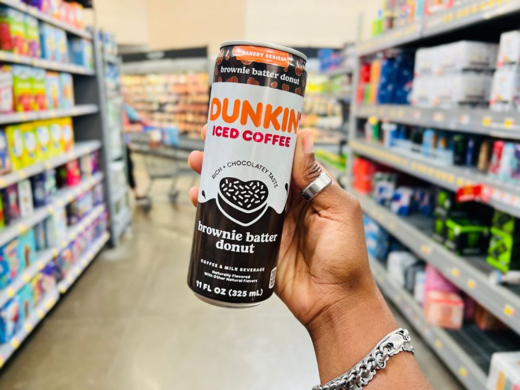 Dunkin' Brownie Batter Donut Iced Coffee 11 fl oz in woman's hand at Walmart