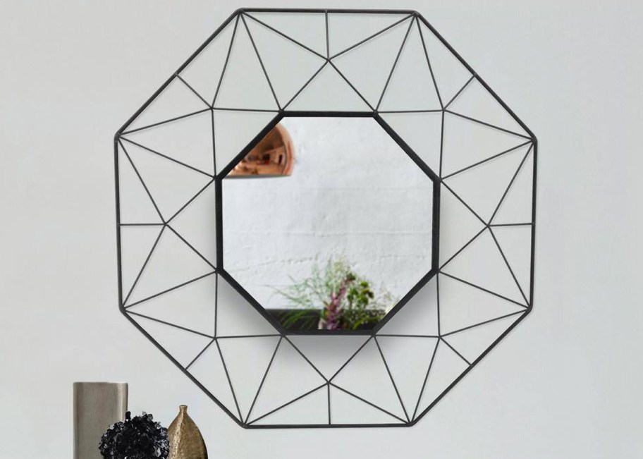 black octagon shaped mirror on wall
