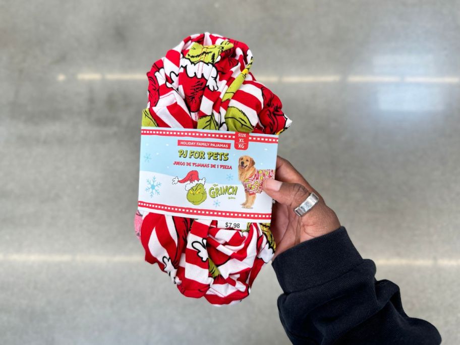 A person holding The Grinch PJ Set for pets