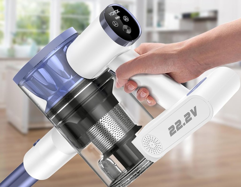 handheld cordless vacuum in persons hand cleaning