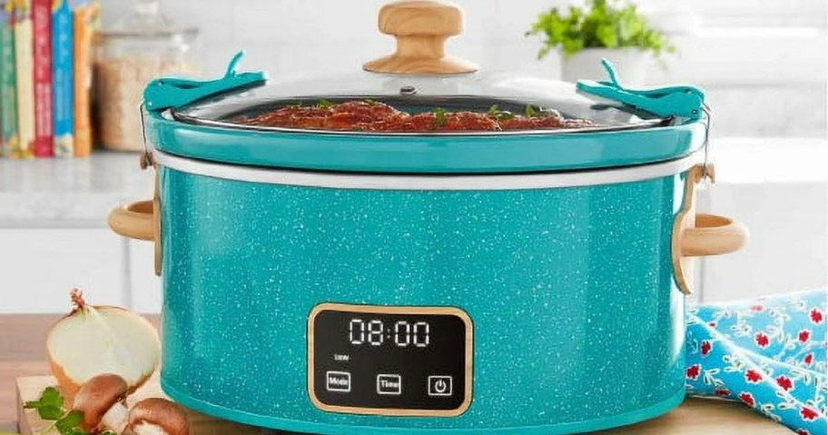 teal slow cooker on table 