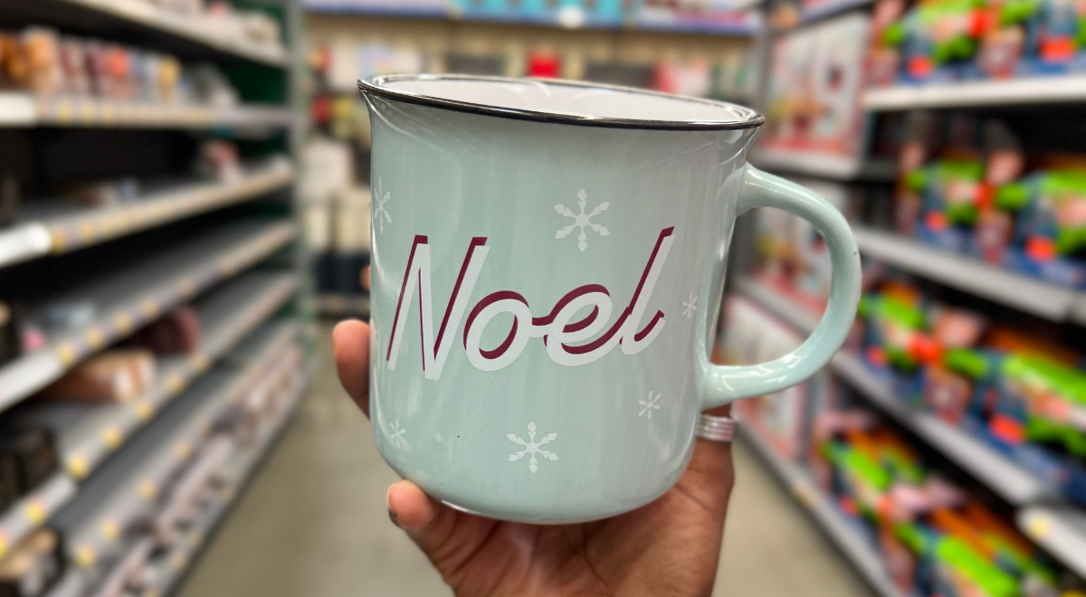 hand holding teal Noel candle mug