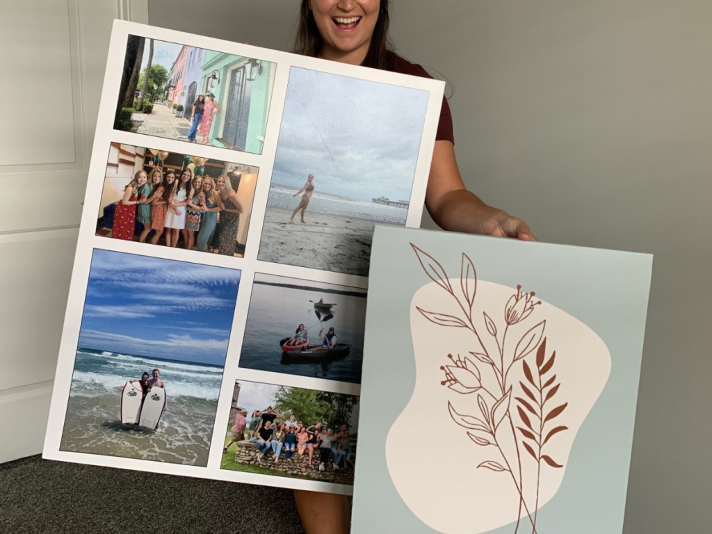 woman holding two canvases