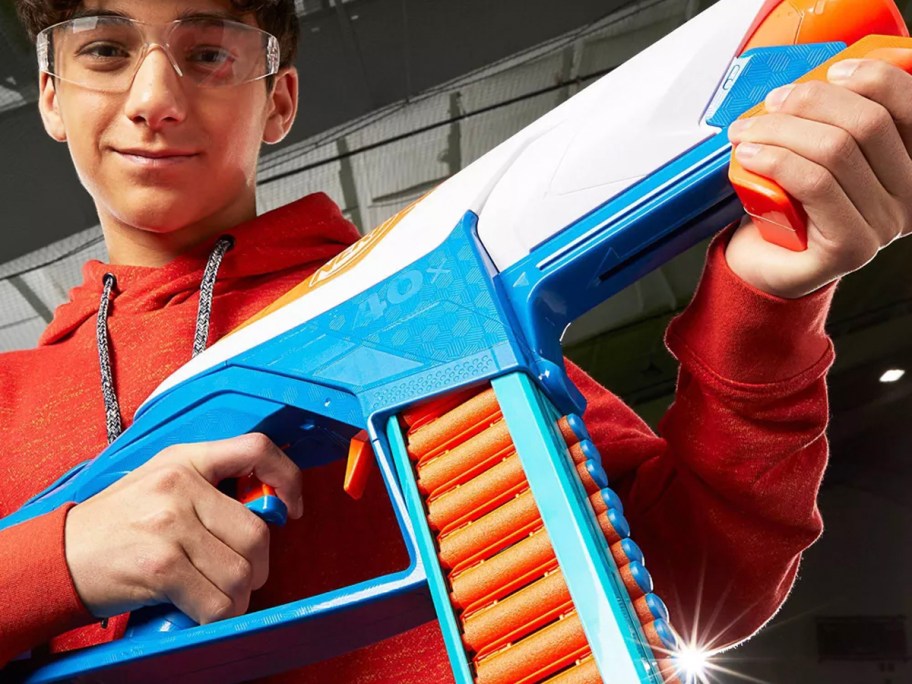 boy holding blue and orange nerf gun