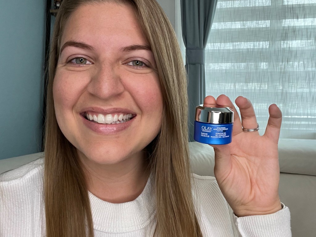 woman holding hyaluronic peptide cream