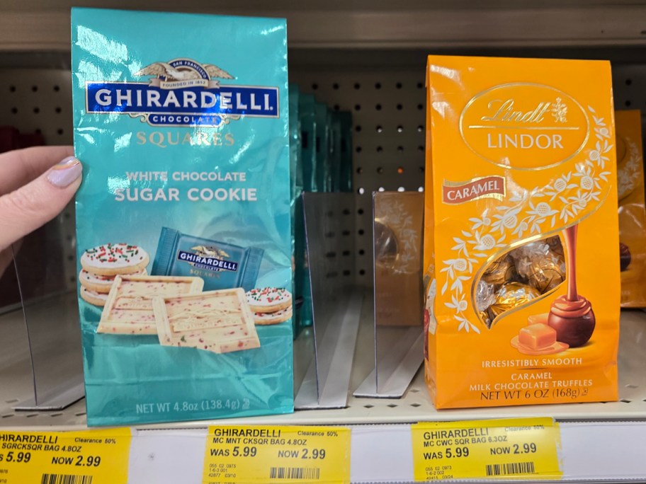 hand reaching for ghirardelli chocolate bag and lindt bag 
