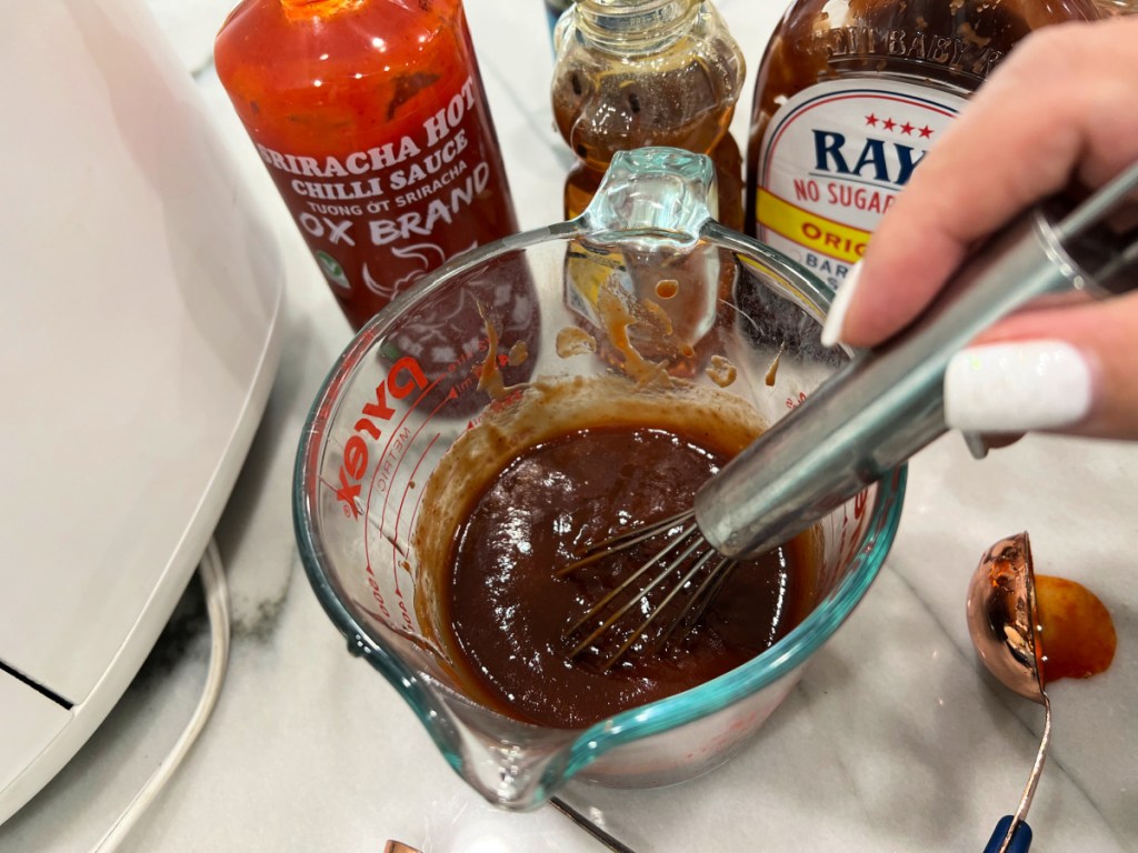 mixing a finishing sauce using a whisk