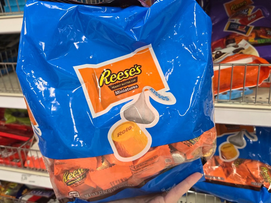 hand holding reese's and rolo candy bag