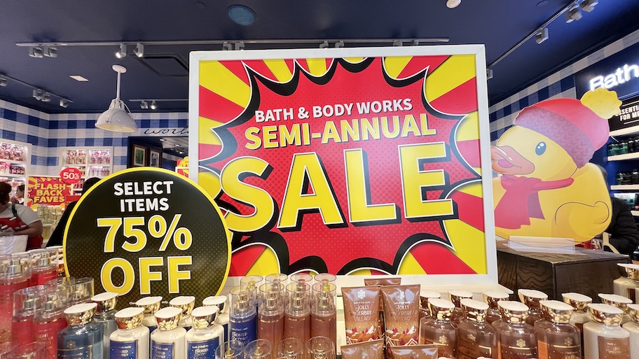 bath and body works semi annual sale sign at store with bottles of lotion and soap what to buy in june 