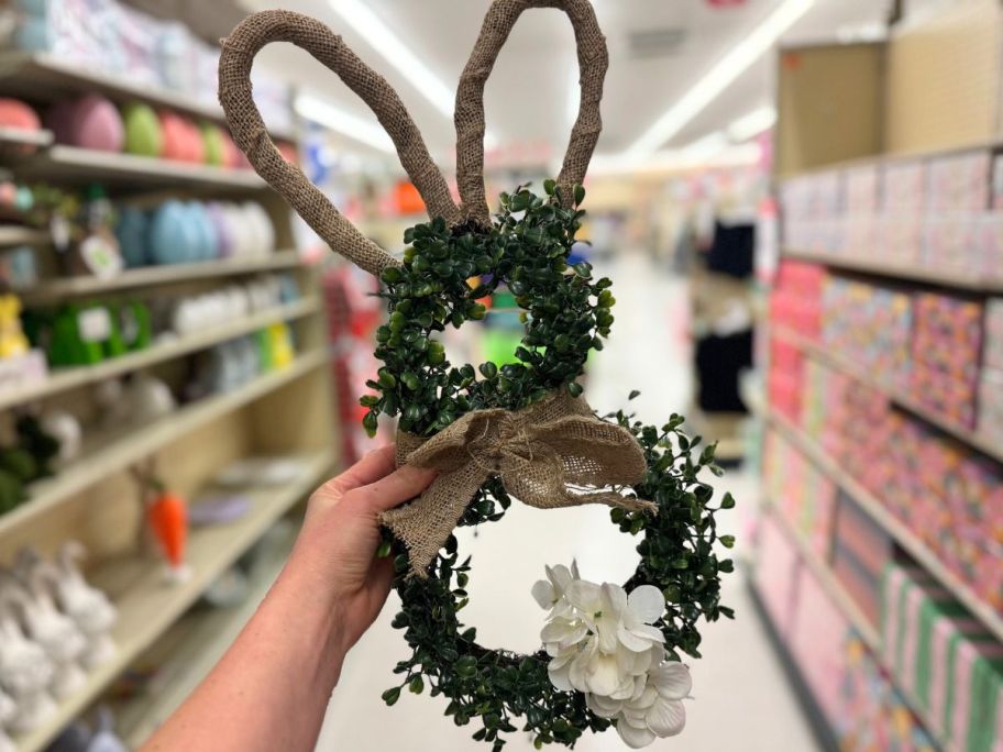 Hand holding a Hobby Lobby Burlap & Greenery Floral Bunny Wreath 