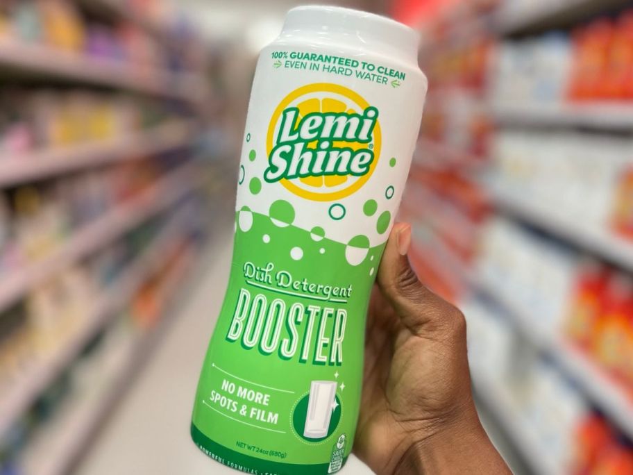 hand holding a bottle of. Lemi Shine Dish Detergent Booster