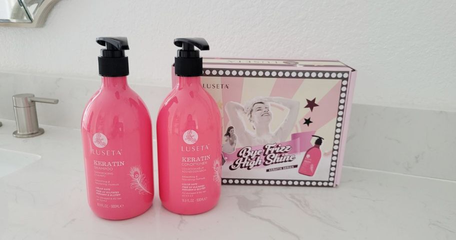 pink bottles of luseta shampoo and conditioner
