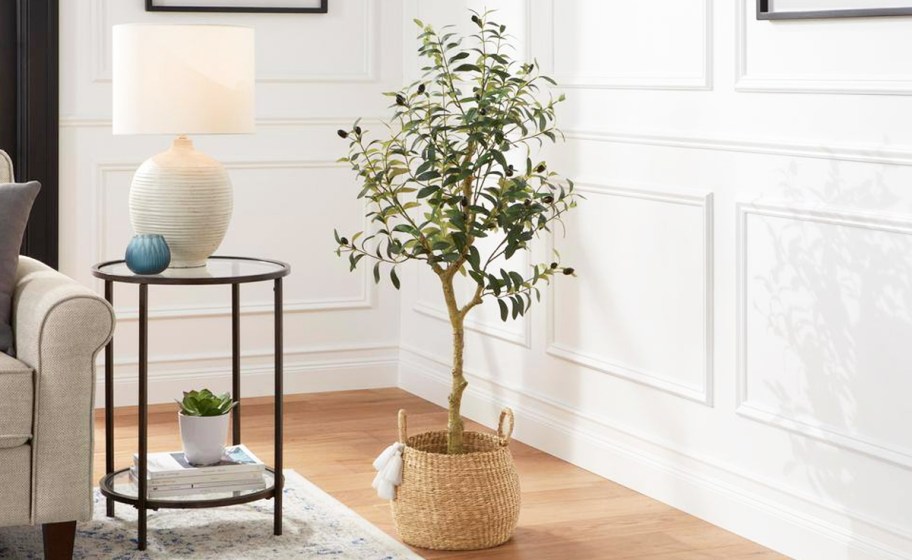 faux olive tree in basket in living room