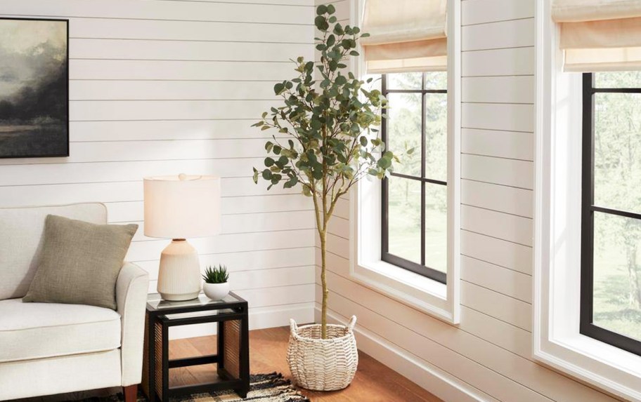 faux Eucalyptus tree in basket in living room