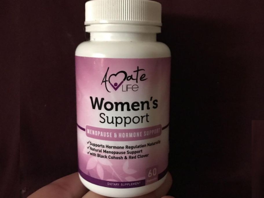 hand holding bottle of Amate Life Support supplement
