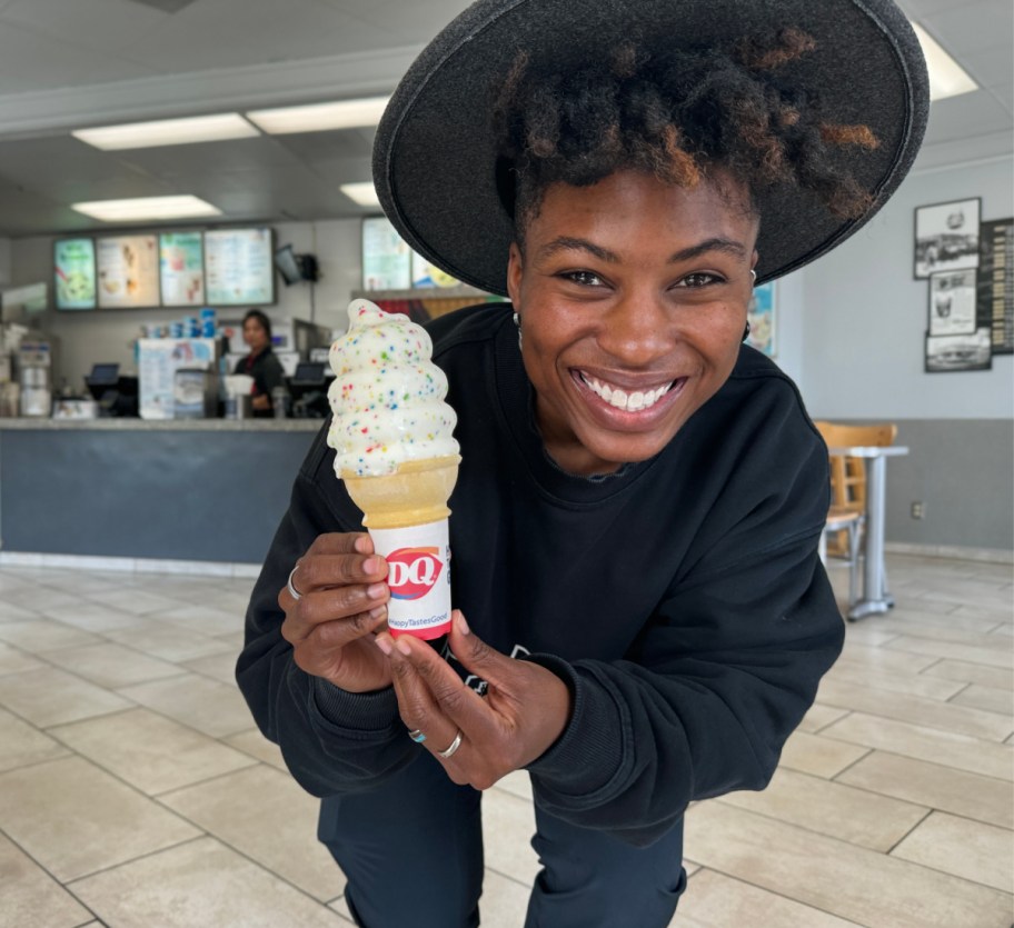 Cam holding the new Dairy Queen menu item, the Confetti Cake Cone in 2024