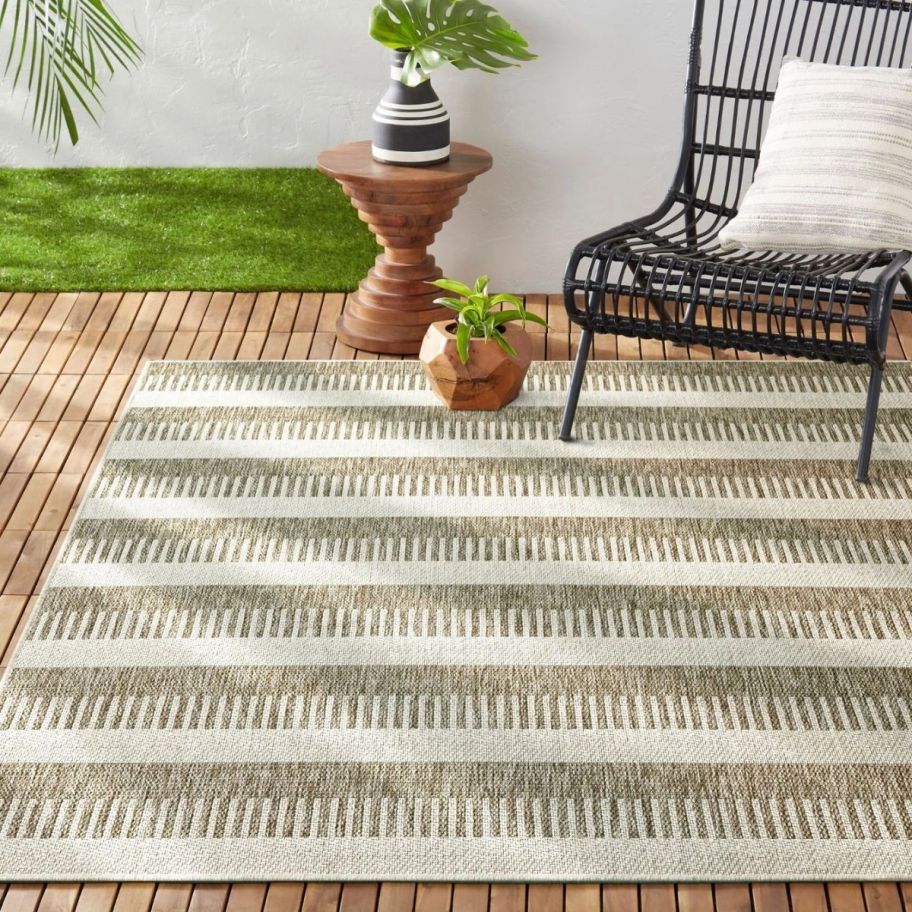 a beige, brown and green geometric patterned outdoor rug