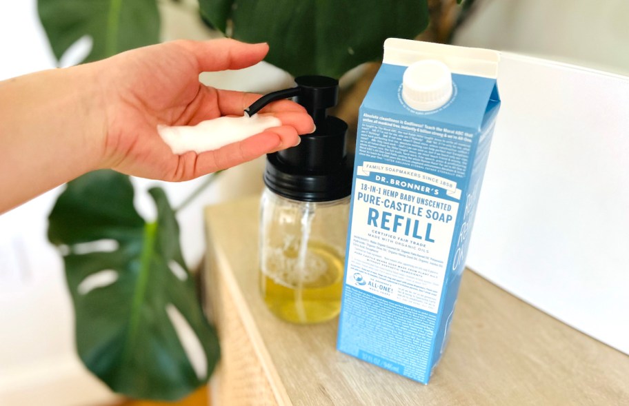 hand squirting dr bronners refill soap on hand