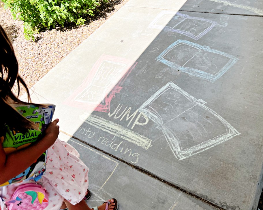 girl standing near chalk obstacle course