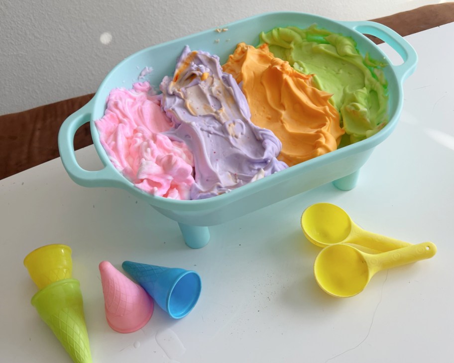 different colored shaving cream in tray with ice cream accessories 