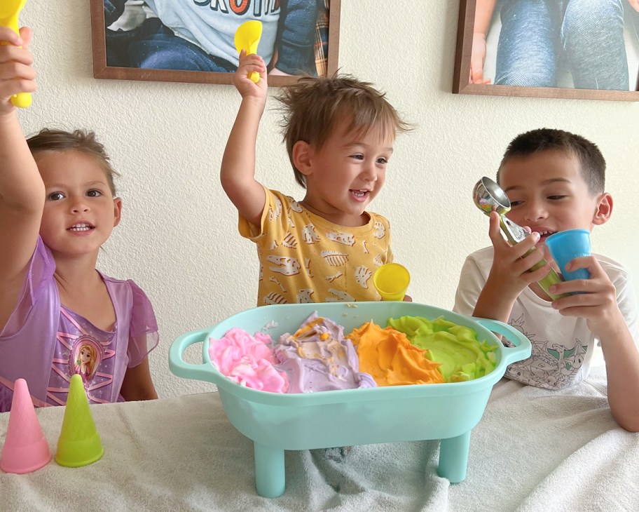 three kids next to tray of shaving cream ice cream