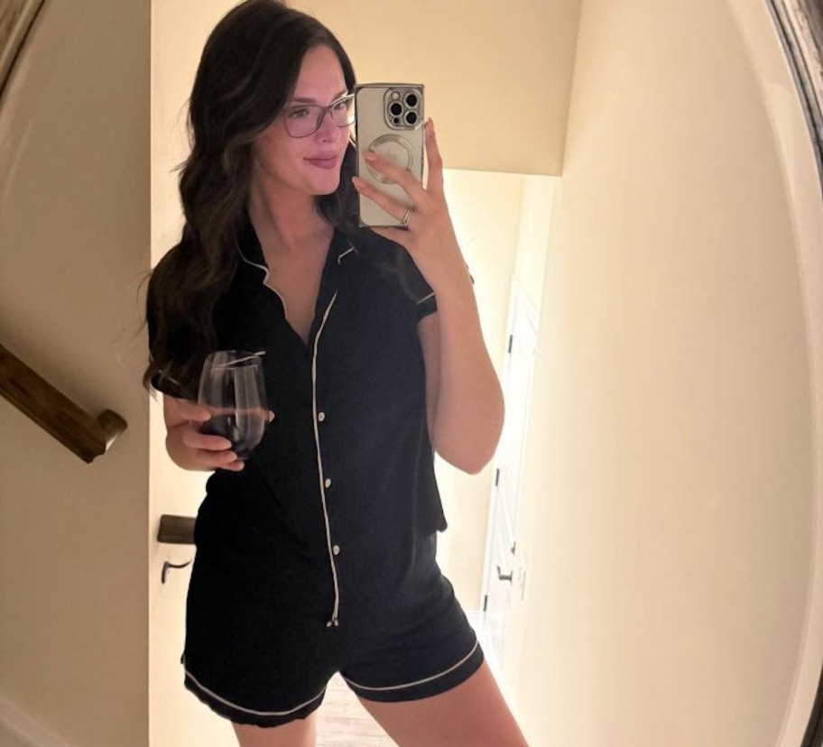 women holding glass of wine wearing pajamas
