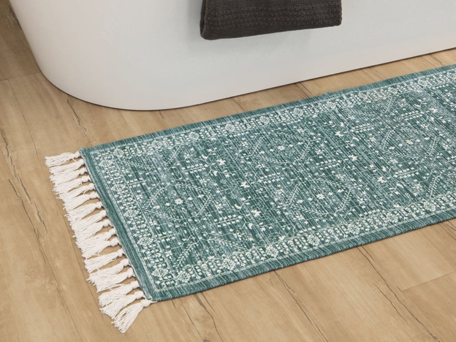 teal runner next to bathtub