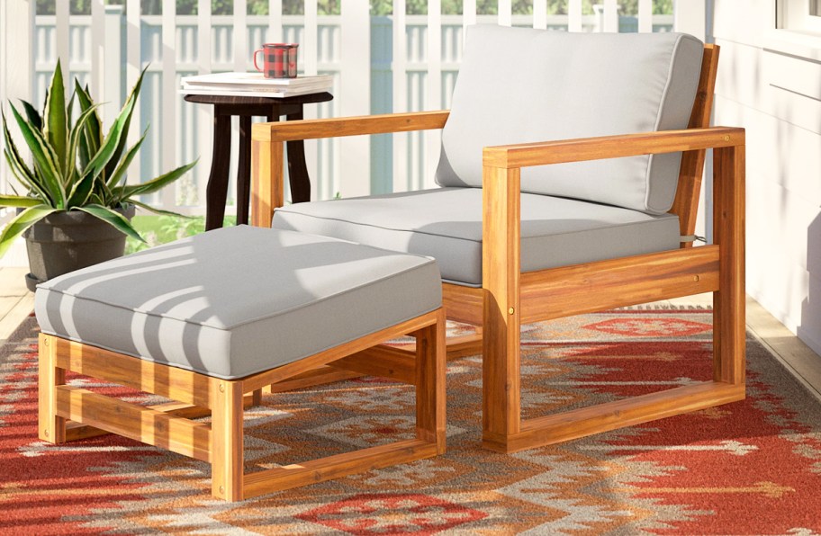 wood patio chair and ottoman set with grey cushions