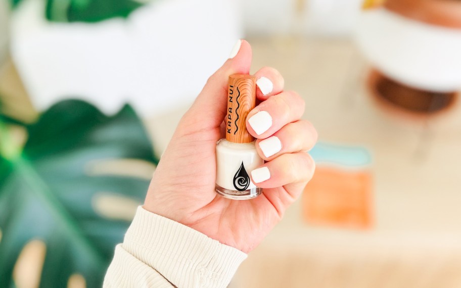 hand holding white bottle of kapa nui nail polish