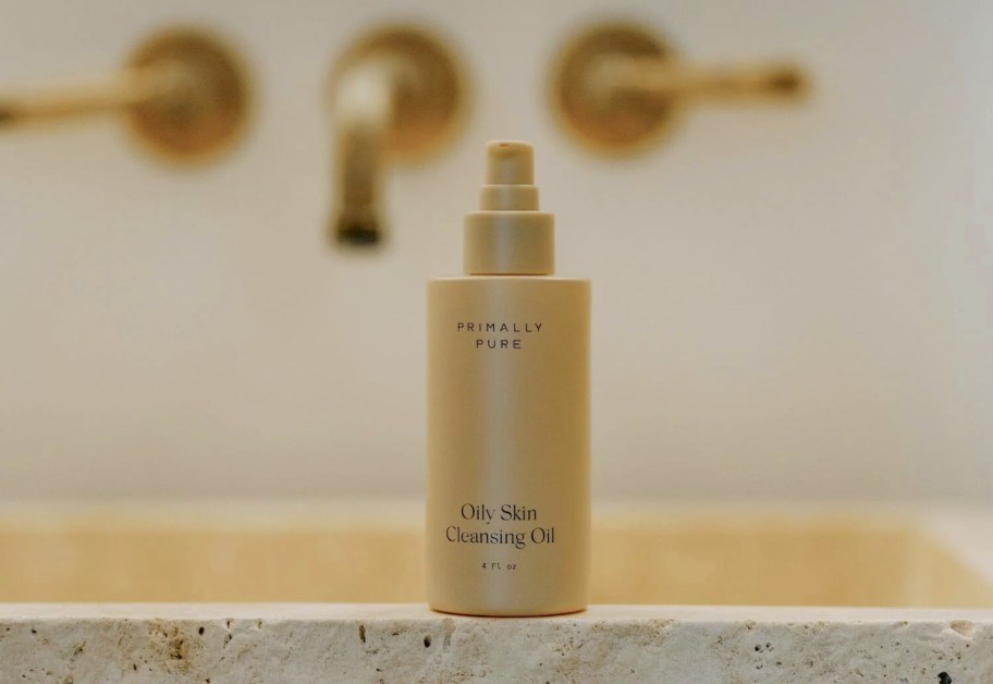 primally pure cleansing oil bottle on stone sink
