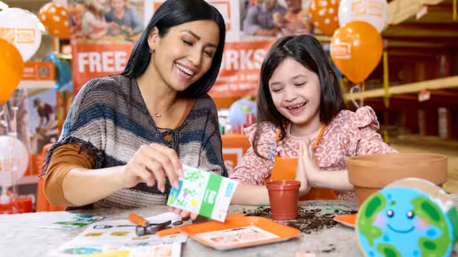 woman and young girl making craft at the home depot