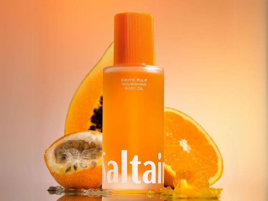 Saltair Nourishing Body Oil with fruit behind it