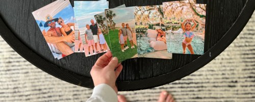 hand grabbing photo magnets off table