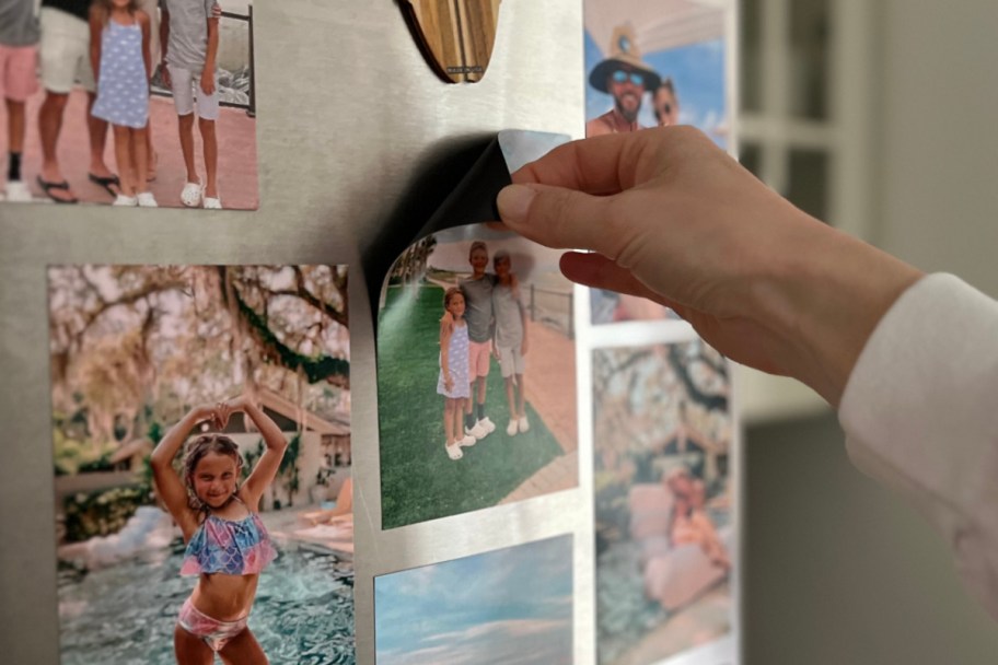 hand grabbing magnet off fridge
