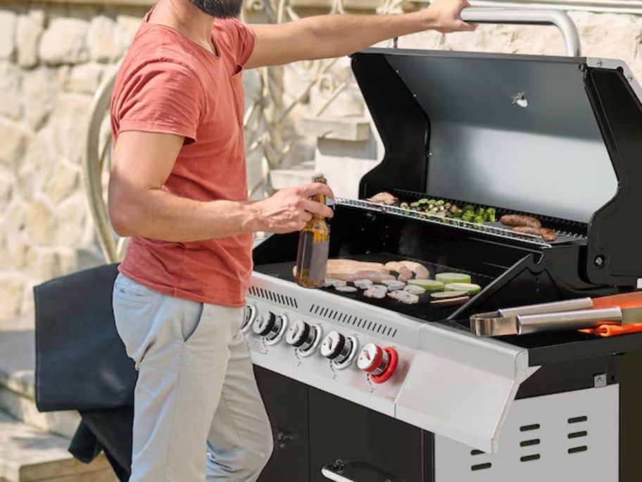 a man grilling food on a large grill