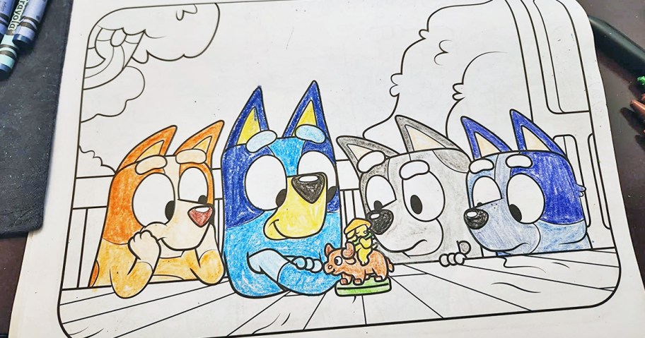 coloring in a bluey coloring book with crayons