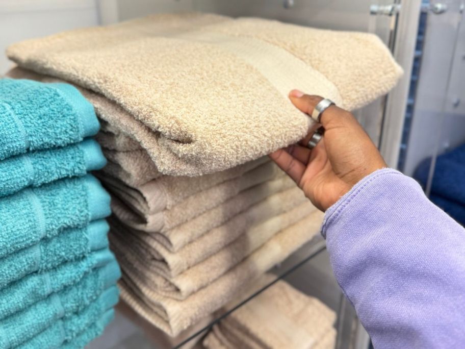 Hand reaching for The big one bath towels at Kohls