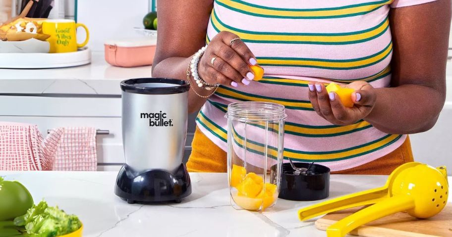 woman using Magic Bullet Single-Serve Blender in kitchen