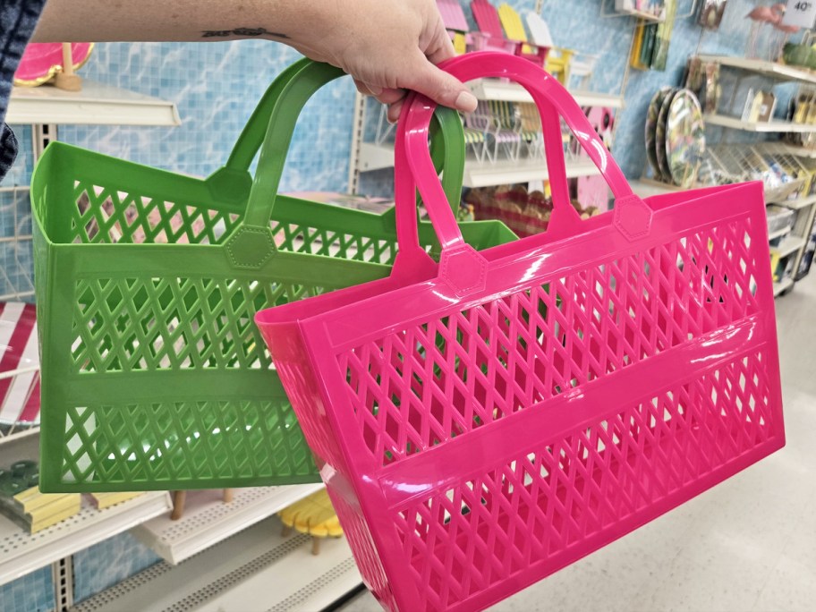 hand holding up green and pink jelly totes in store
