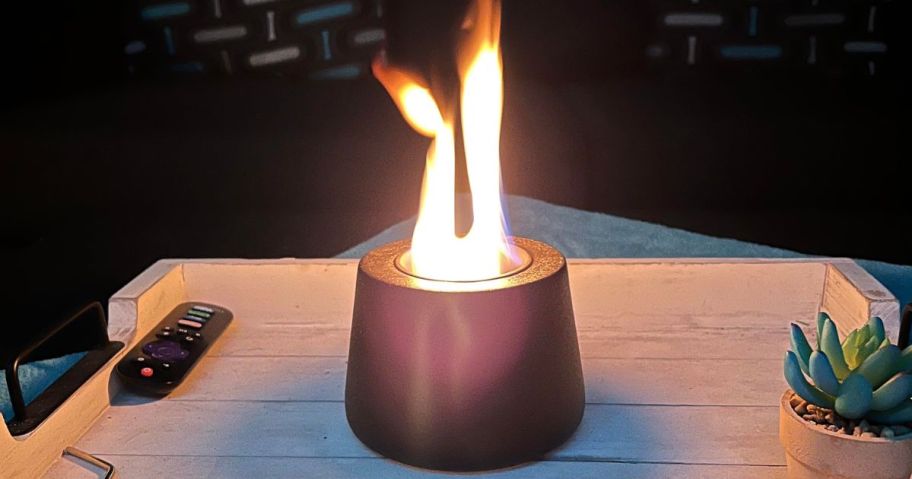 A tabletop fireplace on a patio