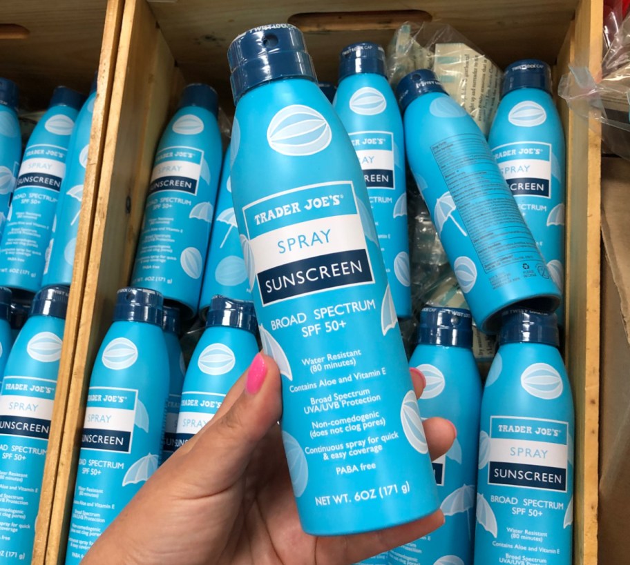 Hand holding up trader joes sunscreen, a best baby sunscreen and best sunscreen for kids
