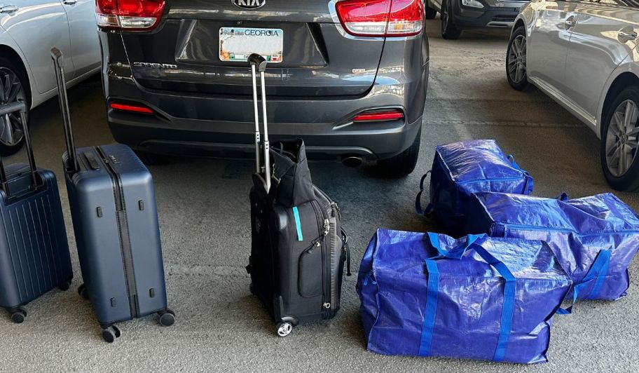 blue storage toest shown with rolling luggage in a parking garage