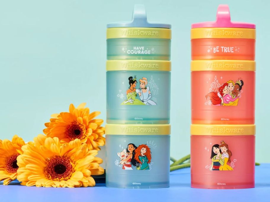 disney princess Whiskware Stackable Snack Container 2-Pack next to yellow flowers