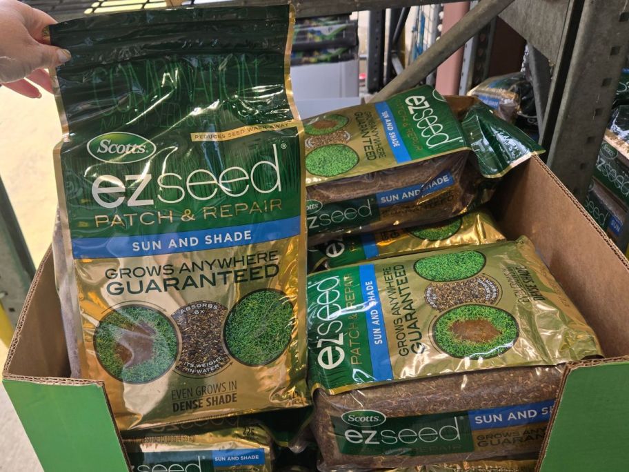 A cardboard bin filled with bags of Scotts ezseed Patch & Repair