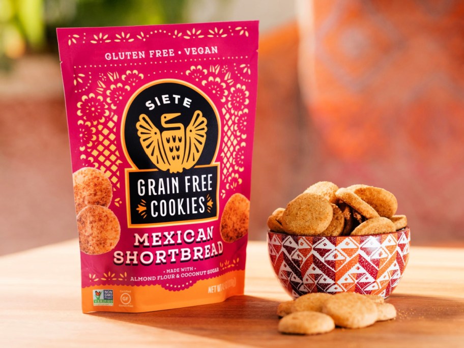 Siete Grain Free Mexican Shortbread Cookies bag next to a decorative bowl of cookies