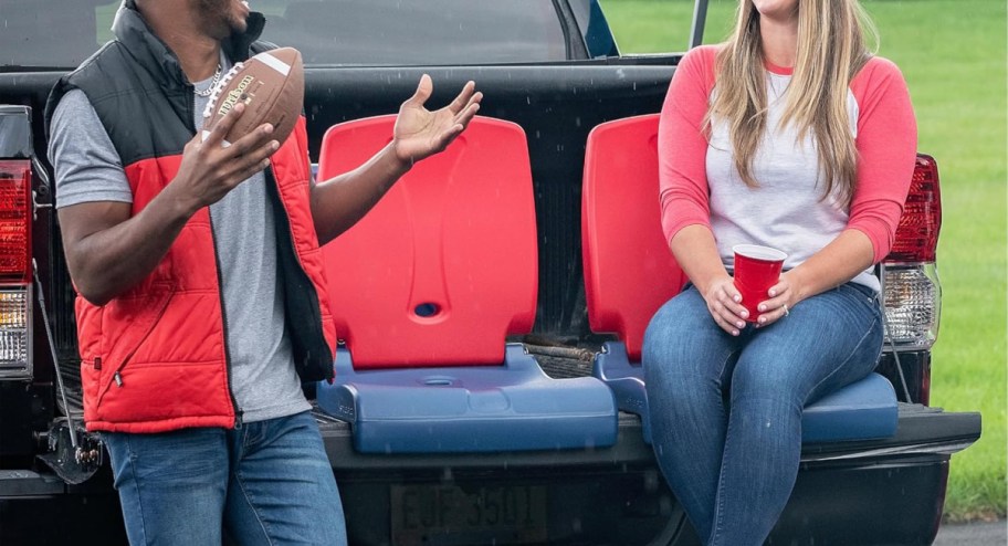 couple sitting on foldable chairs on the car