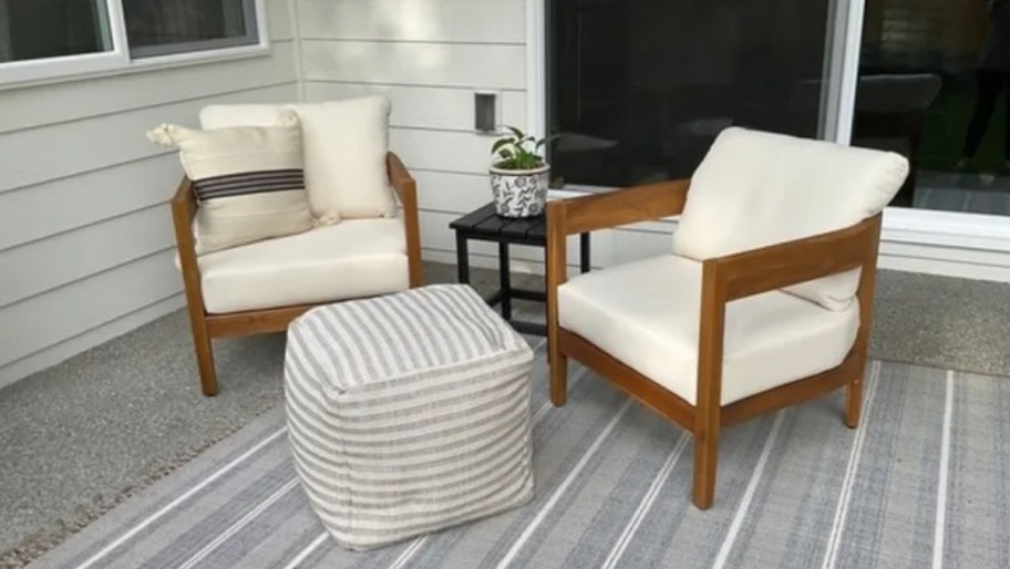 two accent wood chairs sitting on patio