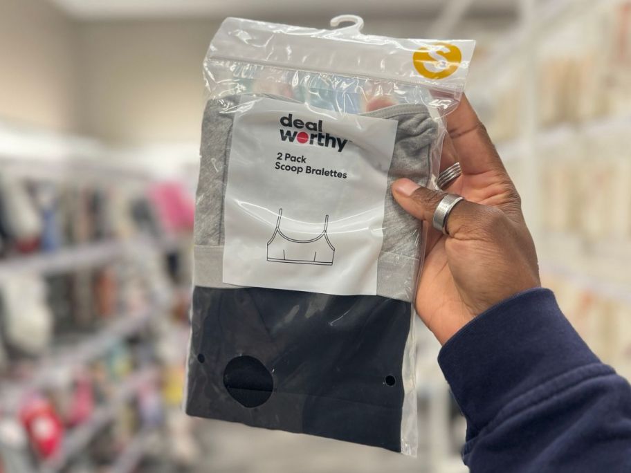 Hand holding up a pack of Dealworthy women's Bralettes at Target