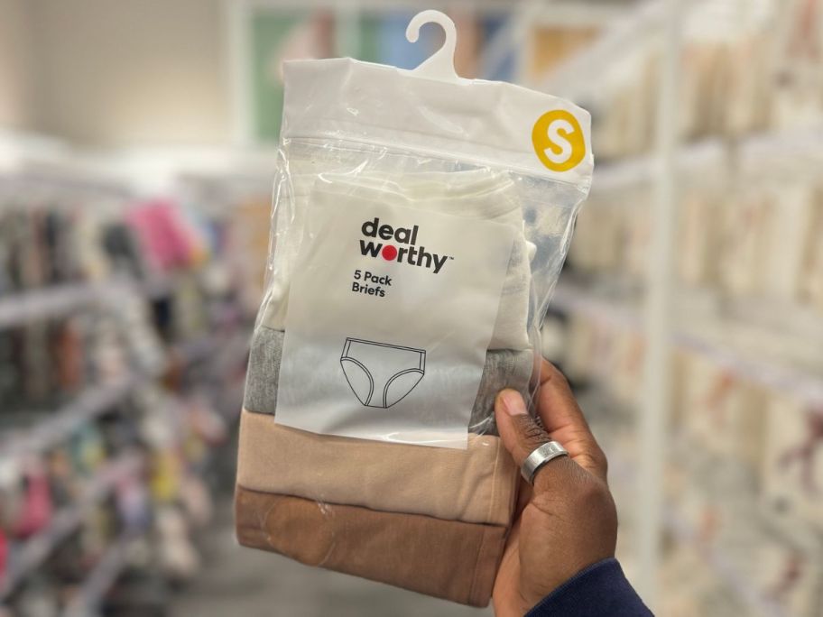 Hand holding up a pack of Dealworthy Women's Underwear at Target