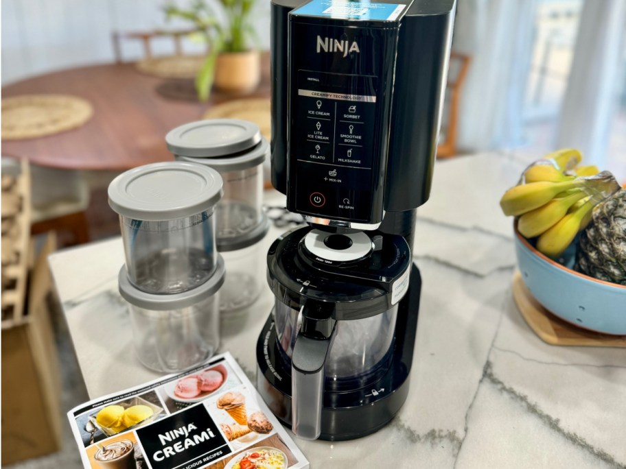 black ninja creami machine with pints on counter